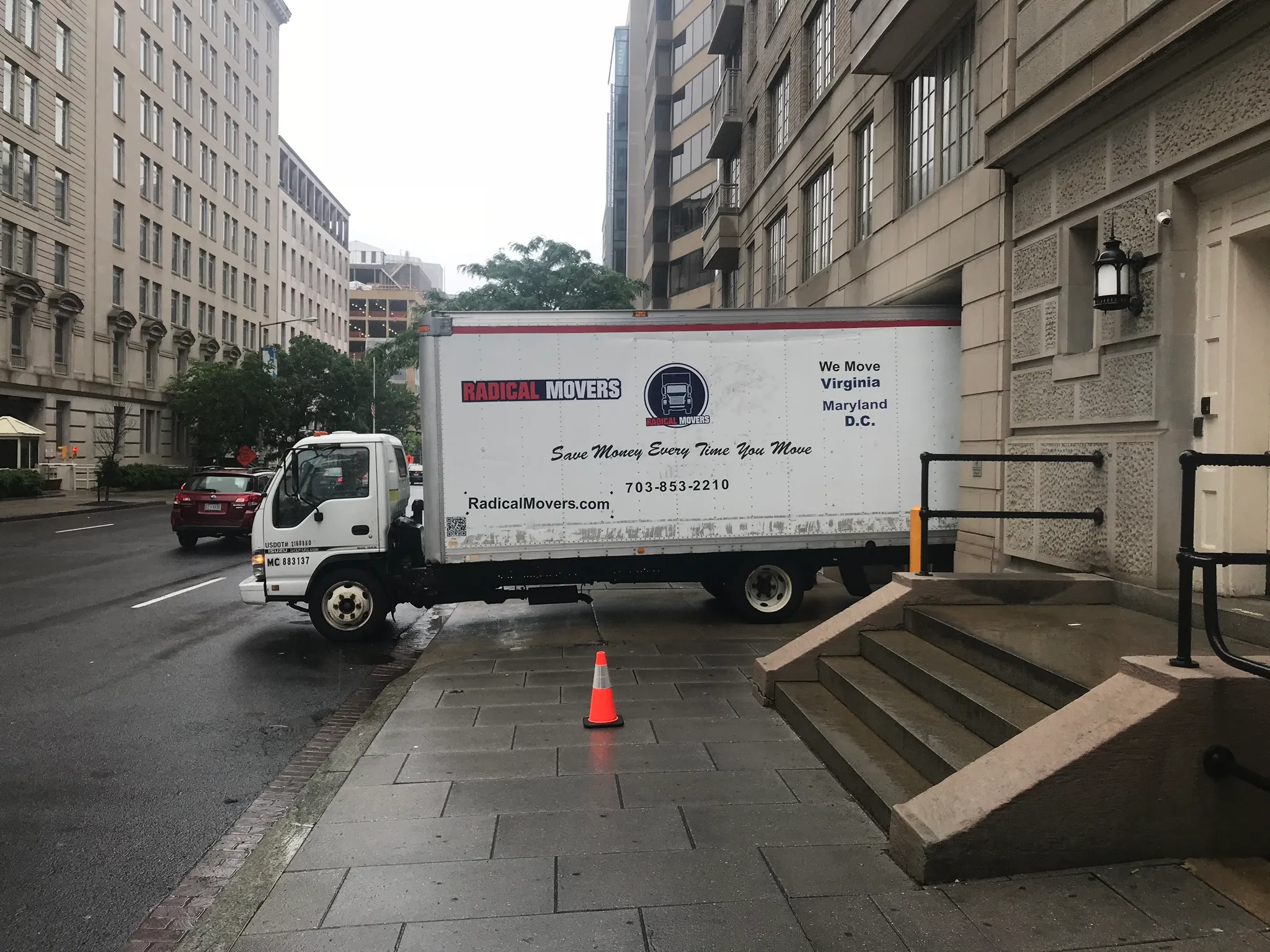 Moving truck with DC parking permit displayed on Washington DC street